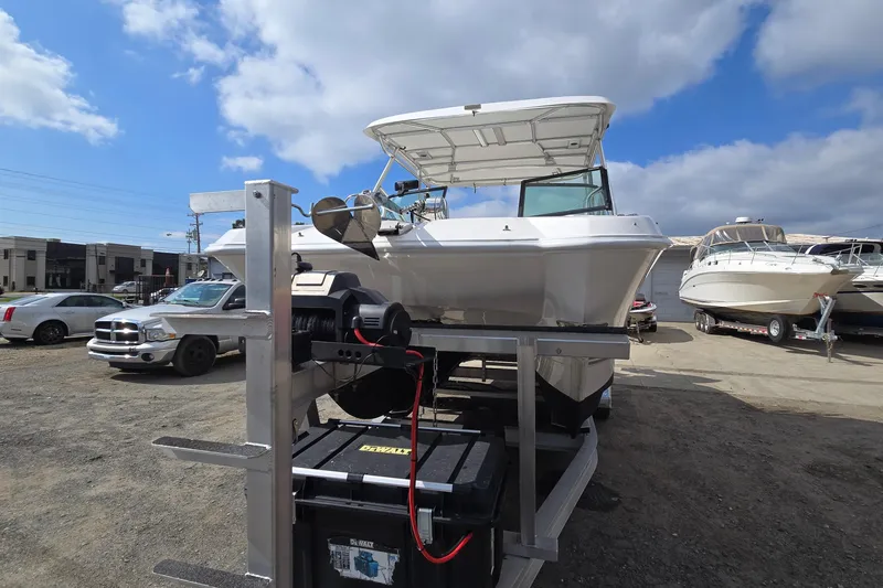 Slide: The Image of 2020 Twin Vee 240 DC GF boat on trailer under a cloudy sky. - 7
