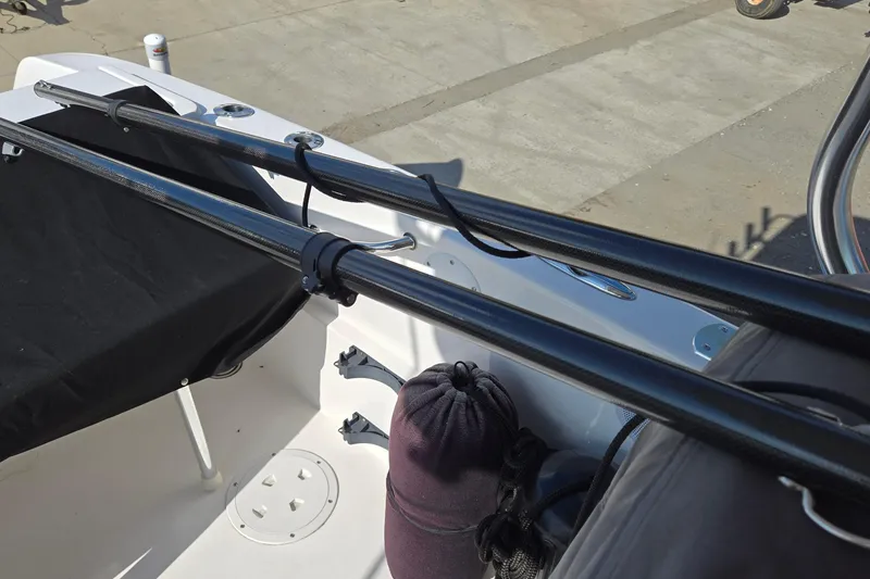 Slide: The Image of 2020 Twin Vee 240 DC GF boat interior with fishing rod holders and storage. - 70