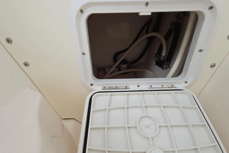 Slide: The Image of Access hatch with hoses inside a 2020 Twin Vee 240 DC GF boat. - 71
