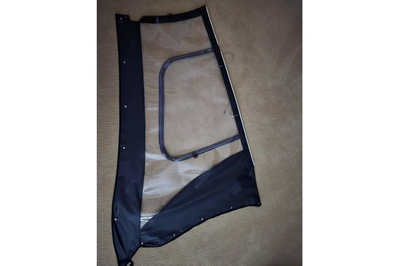 Slide: The Image of Boat window panel for 2020 Twin Vee 240 DC GF, featuring black trim and clear center. - 75