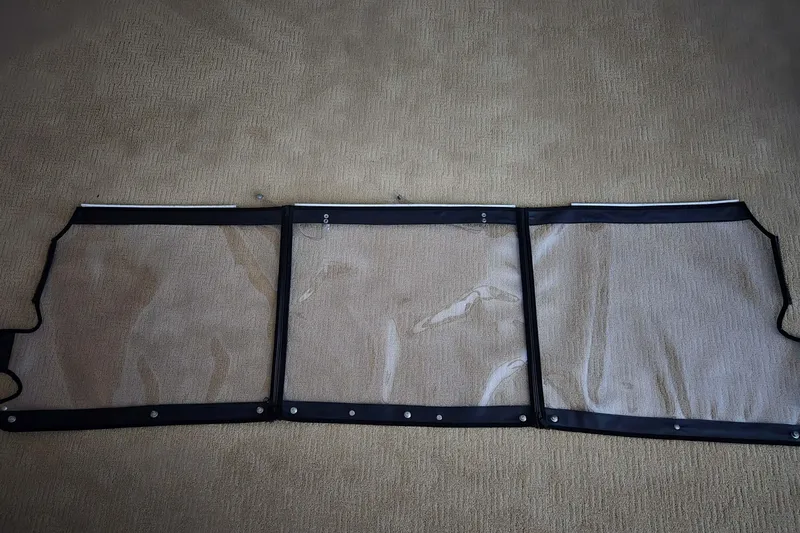 Slide: The Image of Clear boat windshield for 2020 Twin Vee 240 DC GF on beige carpet. - 76