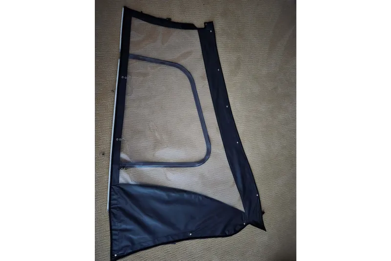 Slide: The Image of Clear boat enclosure panel for 2020 Twin Vee 240 DC GF on beige carpet. - 78