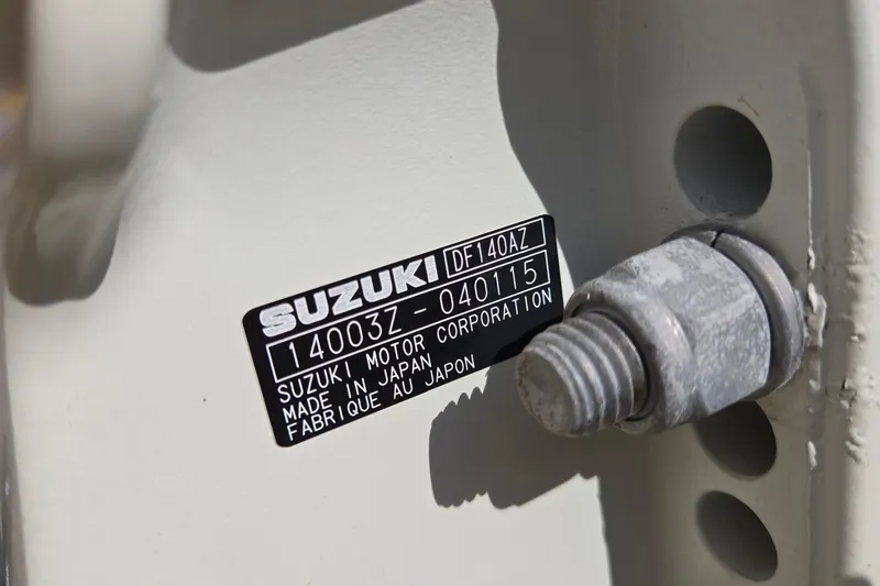 Slide: The Image of Close-up of Suzuki motor label on 2020 Twin Vee 240 DC GF boat. - 79