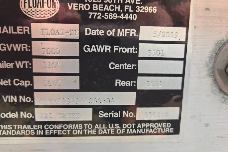 Slide: The Image of Trailer specification plate for Twin Vee 240 DC GF, 2020 model, showing weight and capacity details. - 84