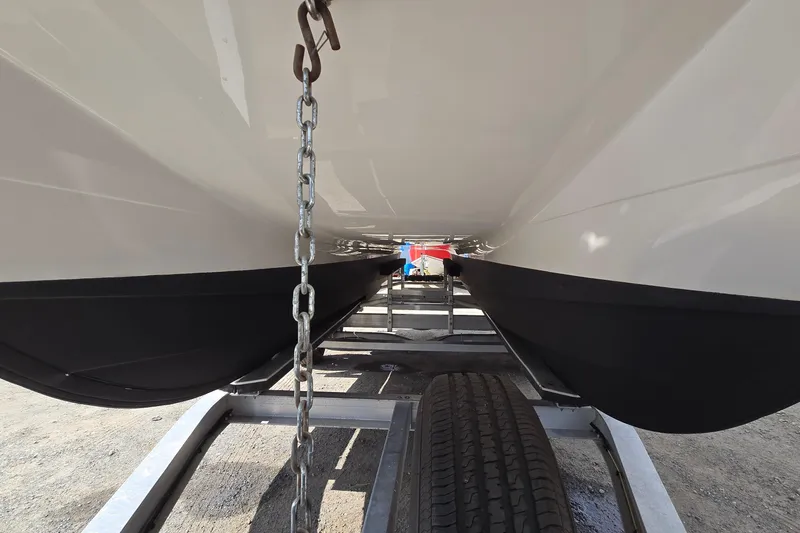 Slide: The Image of Underneath view of 2020 Twin Vee 240 DC GF catamaran on trailer. - 9