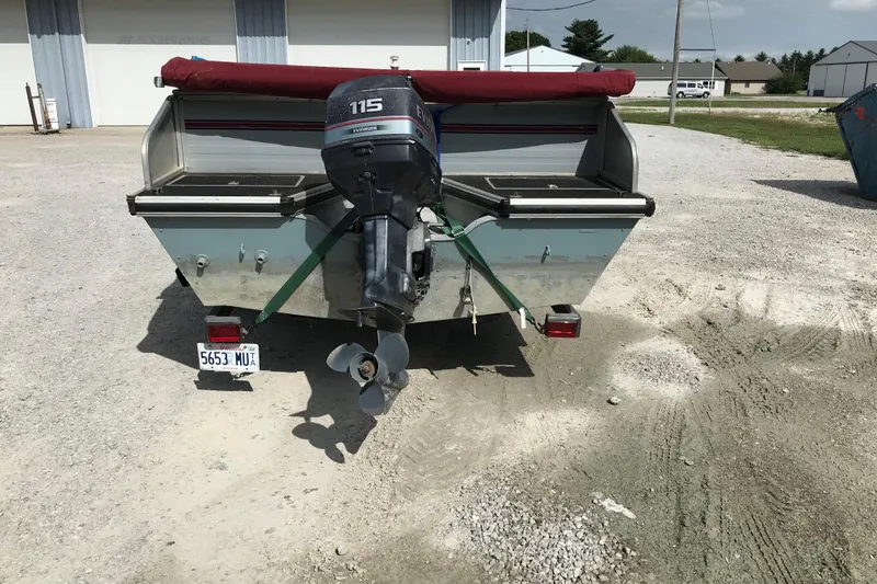 Slide: The Image of Rear view of a 1991 Lowe 2200 boat with an Evinrude 115 outboard motor. - 5