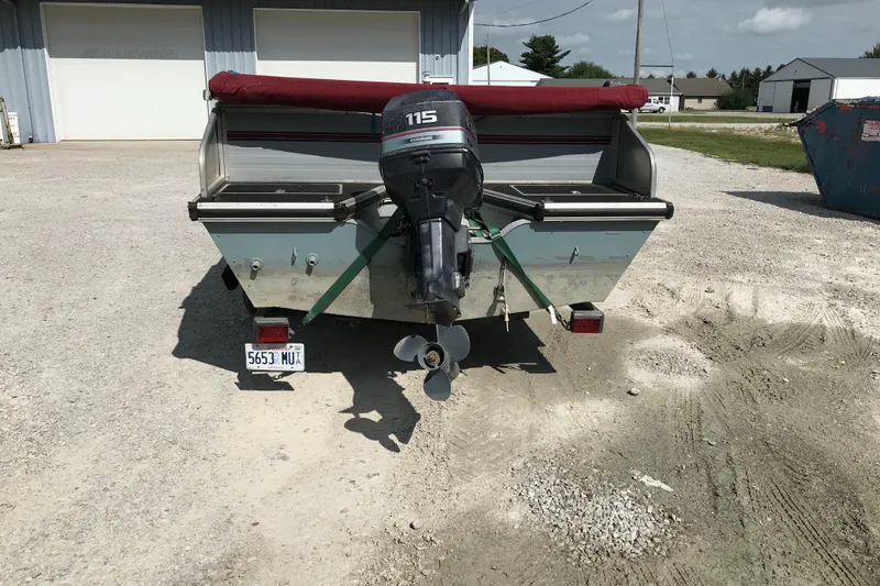 Slide: The Image of Rear view of a 1991 Lowe 2200 boat with an outboard motor. - 7