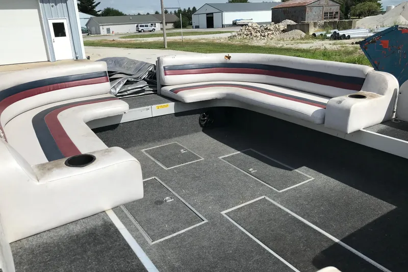 Slide: The Image of 1991 Lowe 2200 boat interior with U-shaped seating and cup holders. - 9