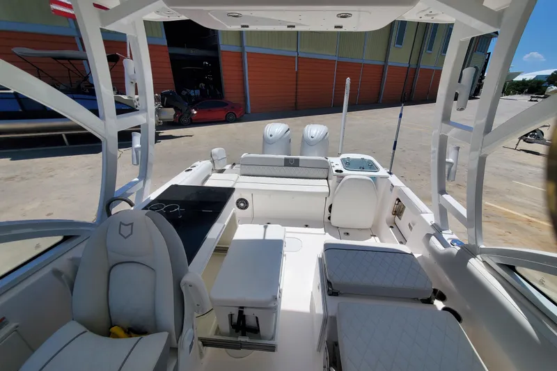Slide: The Image of 2024 Sea Fox 268 Traveler boat interior with seating and dual engines. - 11