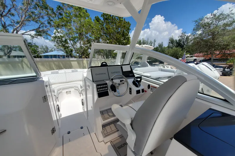 Slide: The Image of 2024 Sea Fox 268 Traveler boat interior with helm, seating, and navigation equipment. - 13