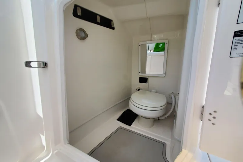 Slide: The Image of 2024 Sea Fox 268 Traveler boat bathroom with toilet and mirror. - 16