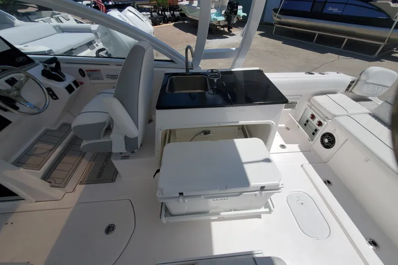 Slide: The Image of 2024 Sea Fox 268 Traveler boat interior with seating, sink, and storage area. - 17
