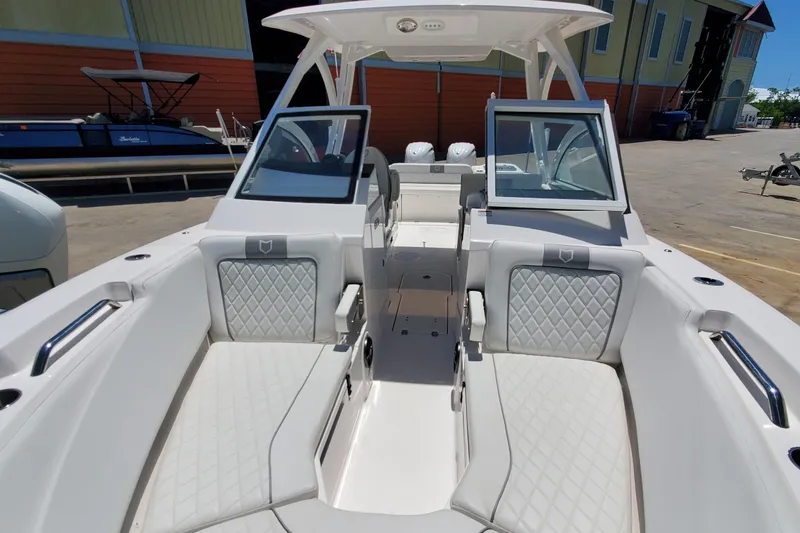 Slide: The Image of 2024 Sea Fox 268 Traveler boat interior with white seating and open windshield. - 18