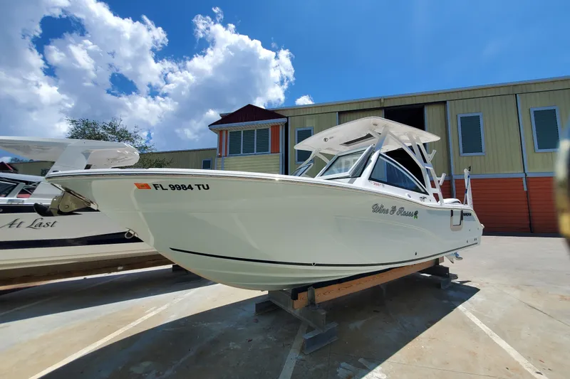 Slide: The Image of 2024 Sea Fox 268 Traveler boat on display under a bright blue sky. - 4