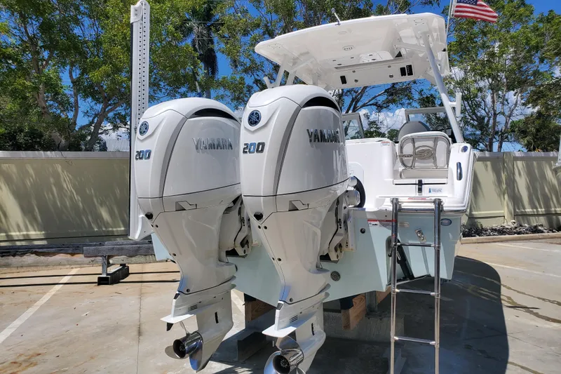 Slide: The Image of 2024 Sea Fox 268 Traveler with dual Yamaha 200 engines, docked outdoors. - 6