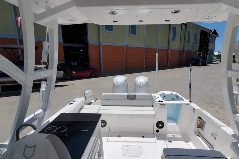 Slide: The Image of 2024 Sea Fox 268 Traveler boat interior with dual engines and seating area. - 7