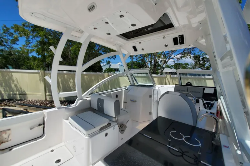 Slide: The Image of 2024 Sea Fox 268 Traveler boat interior with seating, helm, and modern amenities. - 8