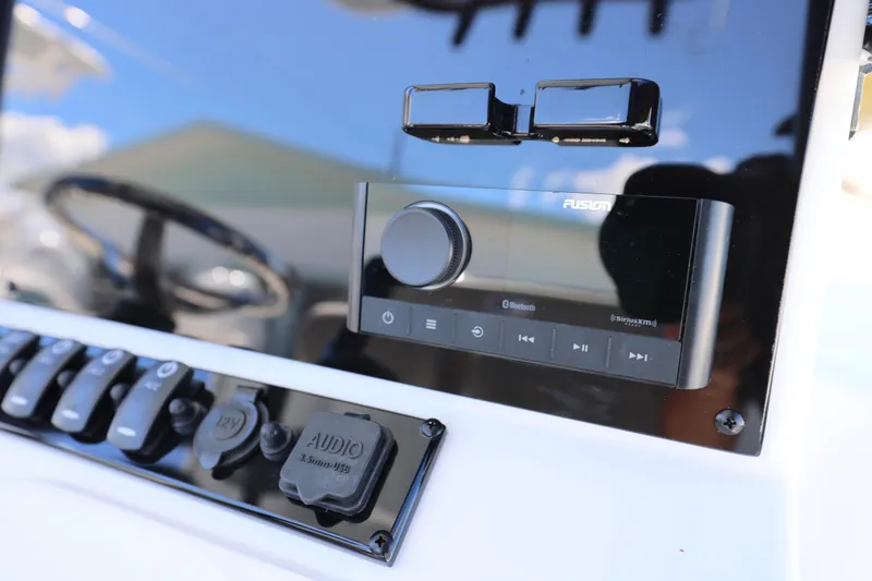 Slide: The Image of Control panel of 2026 Sea Hunt BX 22 BR boat with audio system and switches. - 11