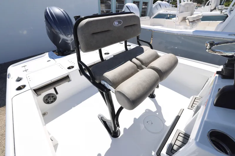 Slide: The Image of 2026 Sea Hunt BX 22 BR boat interior with cushioned seating and motor. - 13