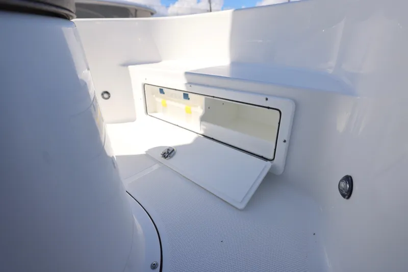 Slide: The Image of 2026 Sea Hunt BX 22 BR boat storage compartment, open and empty, with white interior. - 15