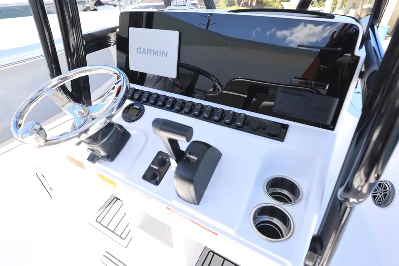 Slide: The Image of 2026 Sea Hunt BX 22 BR boat console with Garmin navigation system and steering wheel. - 22
