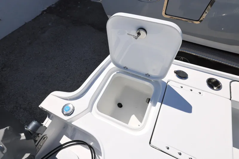 Slide: The Image of 2026 Sea Hunt BX 22 BR boat storage compartment with open lid. - 23