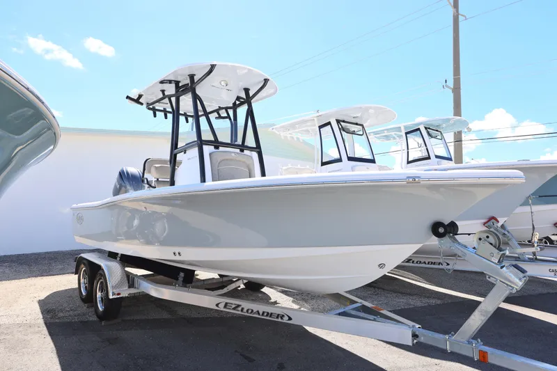 Slide: The Image of 2026 Sea Hunt BX 22 BR boat on trailer under clear blue sky. - 25