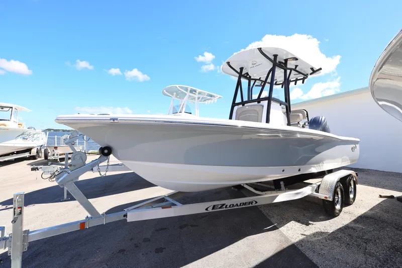 Slide: The Image of 2026 Sea Hunt BX 22 BR boat on trailer under clear blue sky. - 26