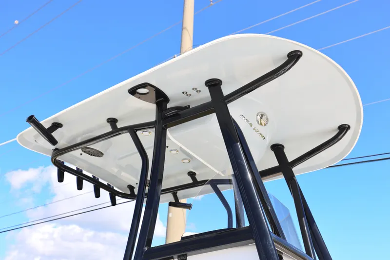 Slide: The Image of 2026 Sea Hunt BX 22 BR boat T-top against a clear blue sky. - 27