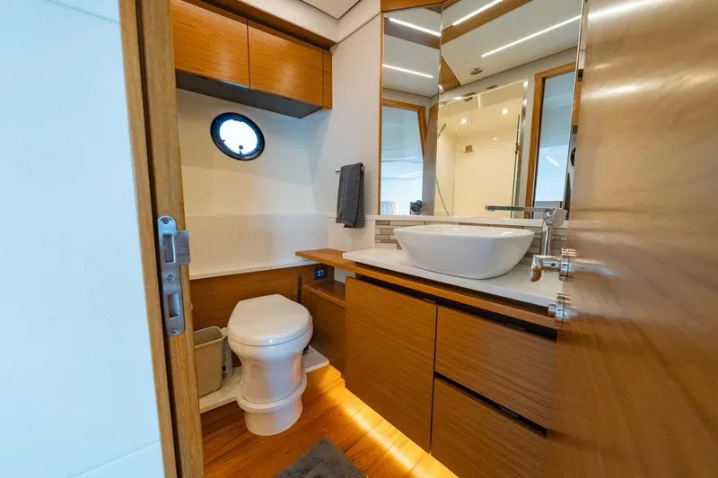 Slide: The Image of Luxurious bathroom in 2022 Tiara Yachts Coupe, featuring modern fixtures and wooden cabinetry. - 18