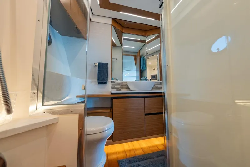 Slide: The Image of Luxurious bathroom interior of 2022 Tiara Yachts Coupe, featuring modern fixtures and elegant design. - 19