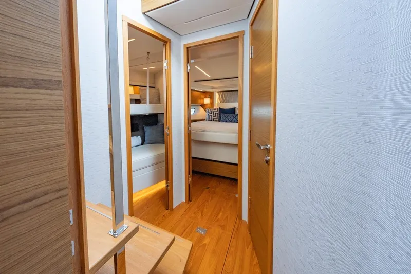 Slide: The Image of Luxurious interior of 2022 Tiara Yachts Coupe, featuring elegant wood finishes and cozy cabins. - 20