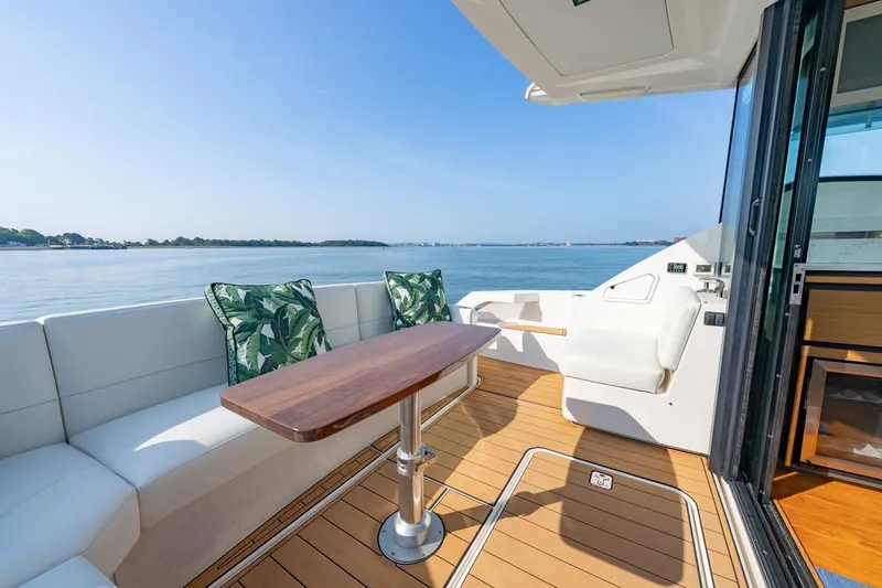 Slide: The Image of Luxurious 2022 Tiara Yachts Coupe with elegant deck seating and scenic ocean view. - 22