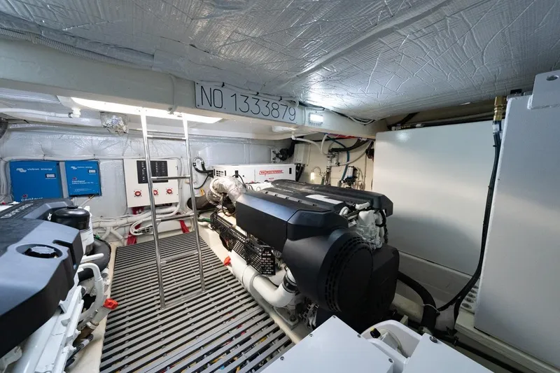 Slide: The Image of Engine room of 2022 Tiara Yachts Coupe, featuring modern equipment and control panels. - 28