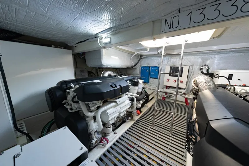 Slide: The Image of Engine room of 2022 Tiara Yachts Coupe, featuring modern equipment and control panels. - 29