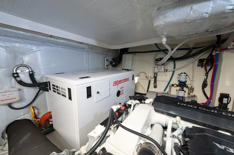 Slide: The Image of Engine room of 2022 Tiara Yachts Coupe with Westerbeke generator and modern equipment. - 30