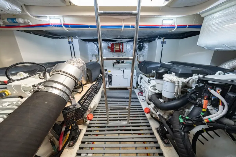 Slide: The Image of Engine room of 2022 Tiara Yachts Coupe, featuring dual engines and ladder access. - 31