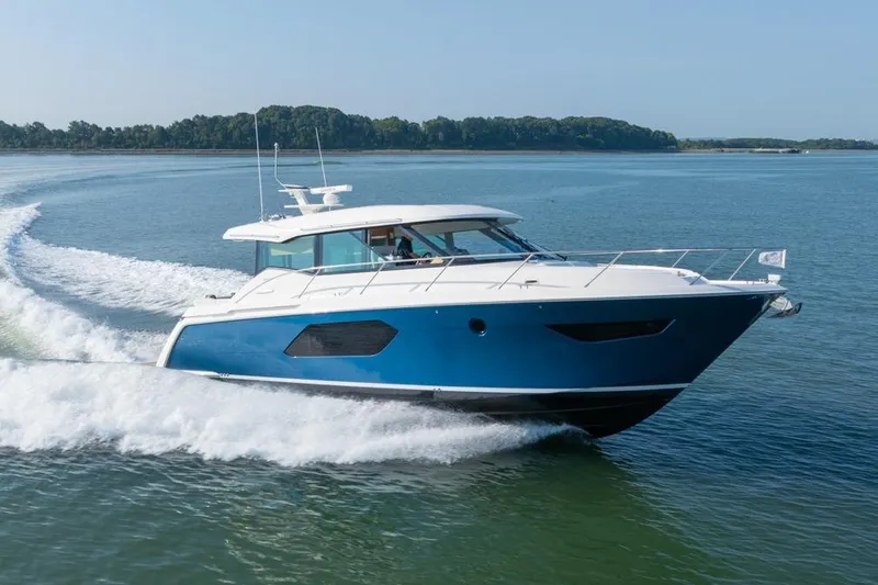 Slide: The Image of 2022 Tiara Yachts Coupe cruising on open water, showcasing sleek design and performance. - 33