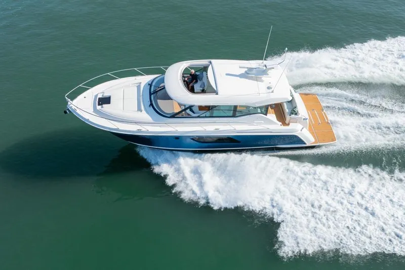 Slide: The Image of 2022 Tiara Yachts Coupe cruising on open water, showcasing sleek design and performance. - 35