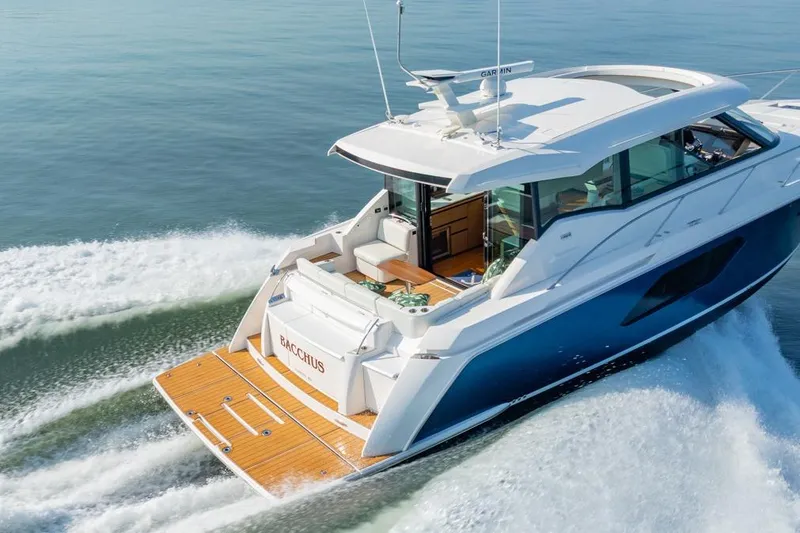 Slide: The Image of 2022 Tiara Yachts Coupe cruising on water, showcasing sleek design and luxury features. - 36