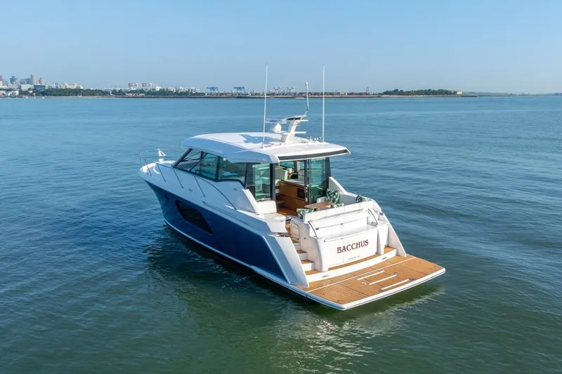 Slide: The Image of 2022 Tiara Yachts C49 Coupe cruising on calm waters, rear view. - 38