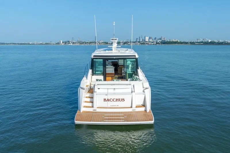 Slide: The Image of 2022 Tiara Yachts Coupe on water, city skyline in background. - 39