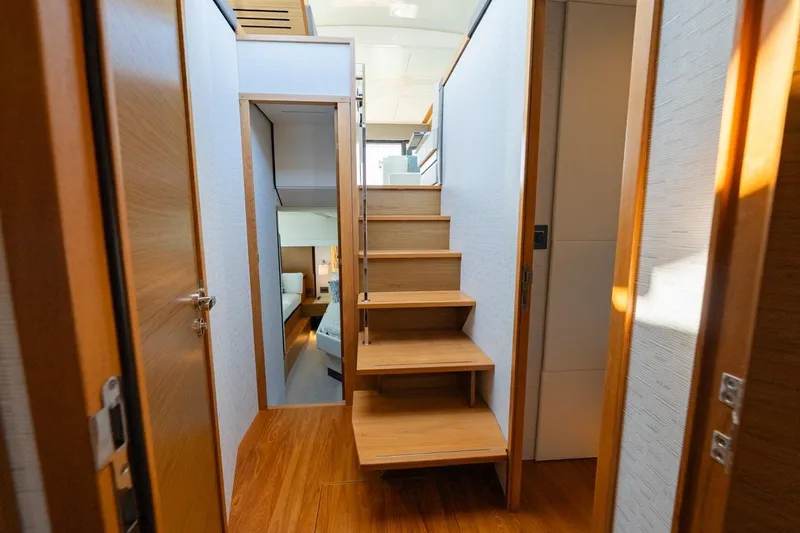 Slide: The Image of 2022 Tiara Yachts Coupe interior with wooden stairs and modern design. - 7