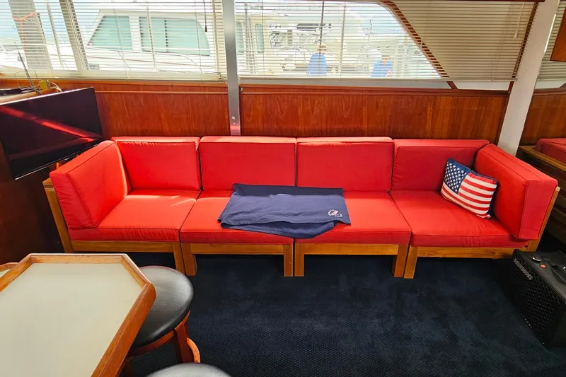 Slide: The Image of Red sofa in 1978 Chris-Craft 410 Commander yacht interior, with American flag pillow. - 15