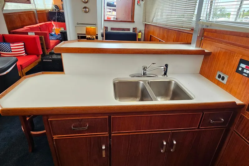 Slide: The Image of 1978 Chris-Craft 410 Commander yacht interior with dual sink and wooden cabinetry. - 20