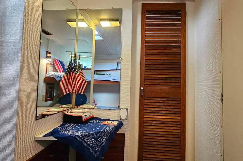 Slide: The Image of 1978 Chris-Craft 410 Commander interior with mirror, wooden door, and American flags. - 30