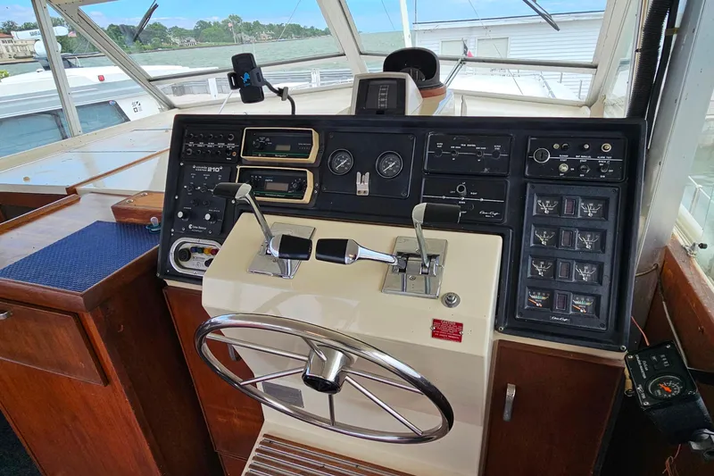 Slide: The Image of 1978 Chris-Craft 410 Commander helm with steering wheel and control panel. - 7