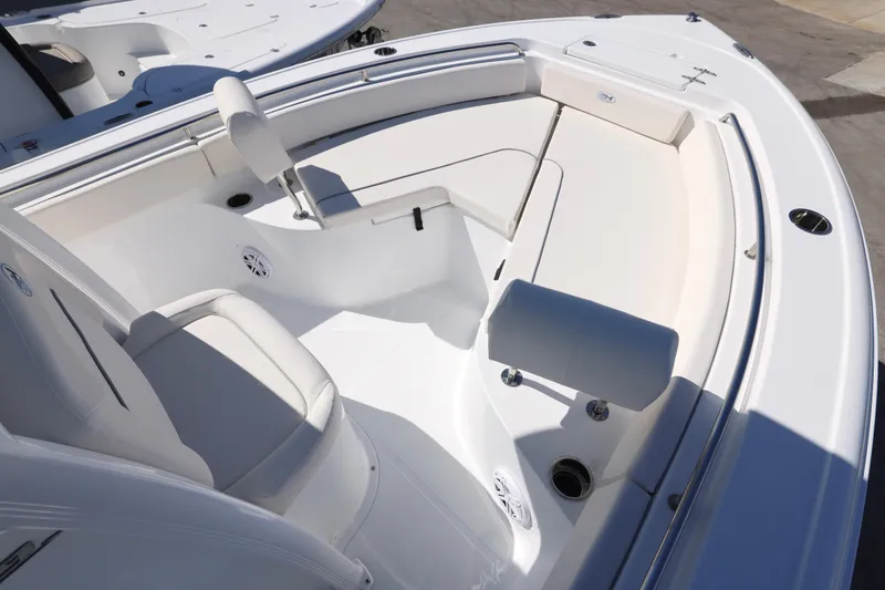 Slide: The Image of 2026 Sea Hunt Ultra 229 boat interior with white seating and sleek design. - 14
