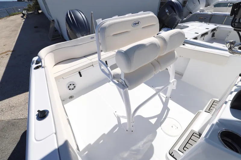 Slide: The Image of 2026 Sea Hunt Ultra 229 boat interior with white seating and clean deck. - 18
