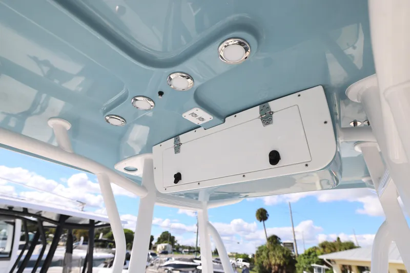 Slide: The Image of 2026 Sea Hunt Ultra 229 boat roof with built-in lights and storage compartment. - 19